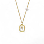 A 14K gold plated vintage rectangular sunburst pendant featuring a dancing pave initial letter Y and a side freshwater pearl, isolated on a white background.