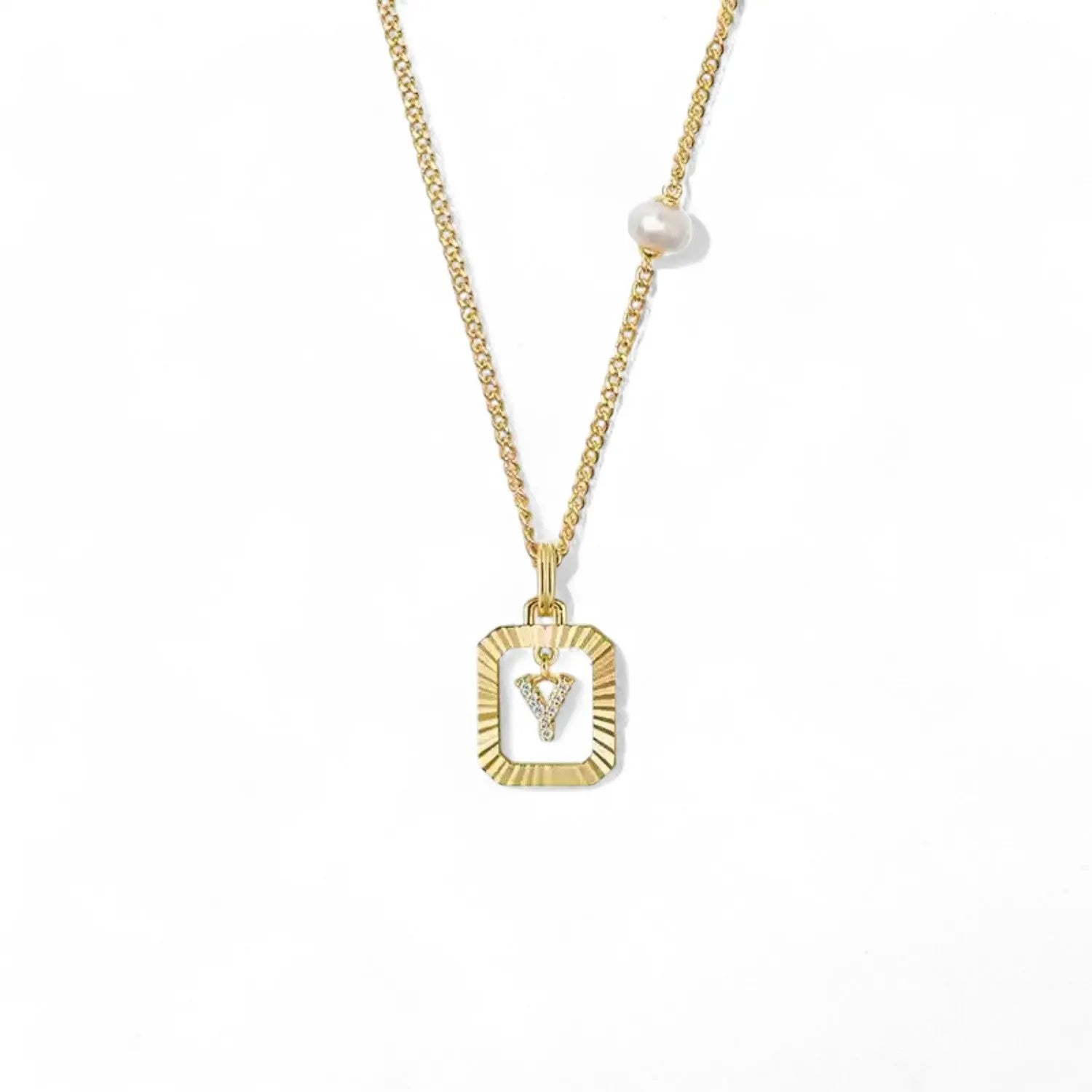 A 14K gold plated vintage rectangular sunburst pendant featuring a dancing pave initial letter Y and a side freshwater pearl, isolated on a white background.