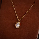 Detailed angled shot of the "bathtub" style thick gold bezel encasing the brilliant oval lab-grown diamond.