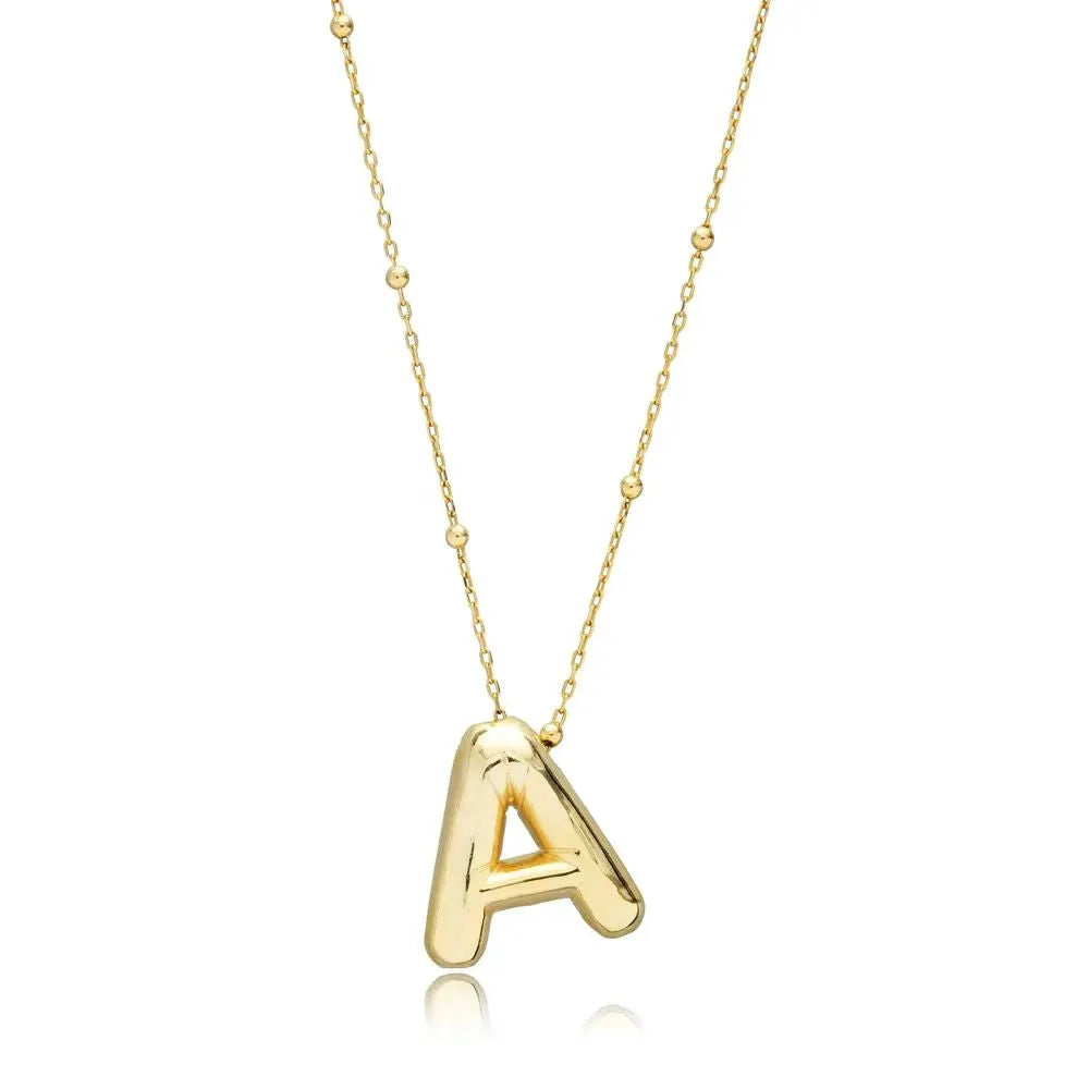 A shiny 18K gold plated 3D puff initial letter A pendant suspended on a delicate beaded bean chain, isolated on a white background.