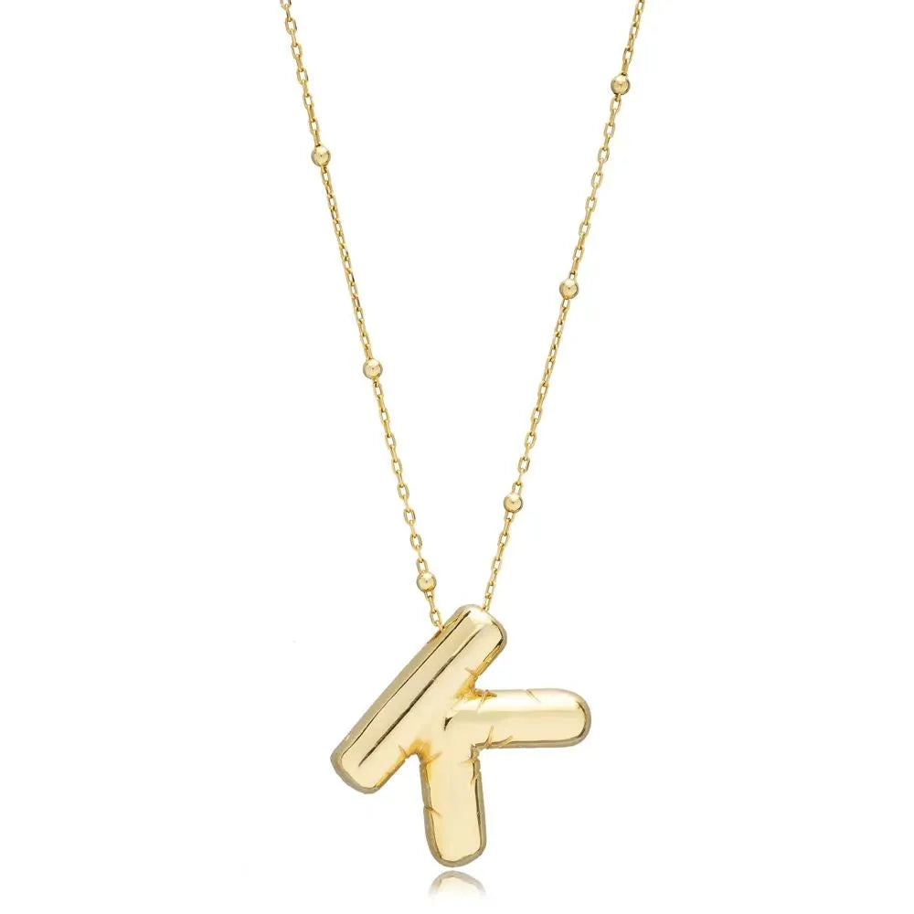 A shiny 18K gold plated 3D puff initial letter K pendant on a bean chain, isolated on a white background.