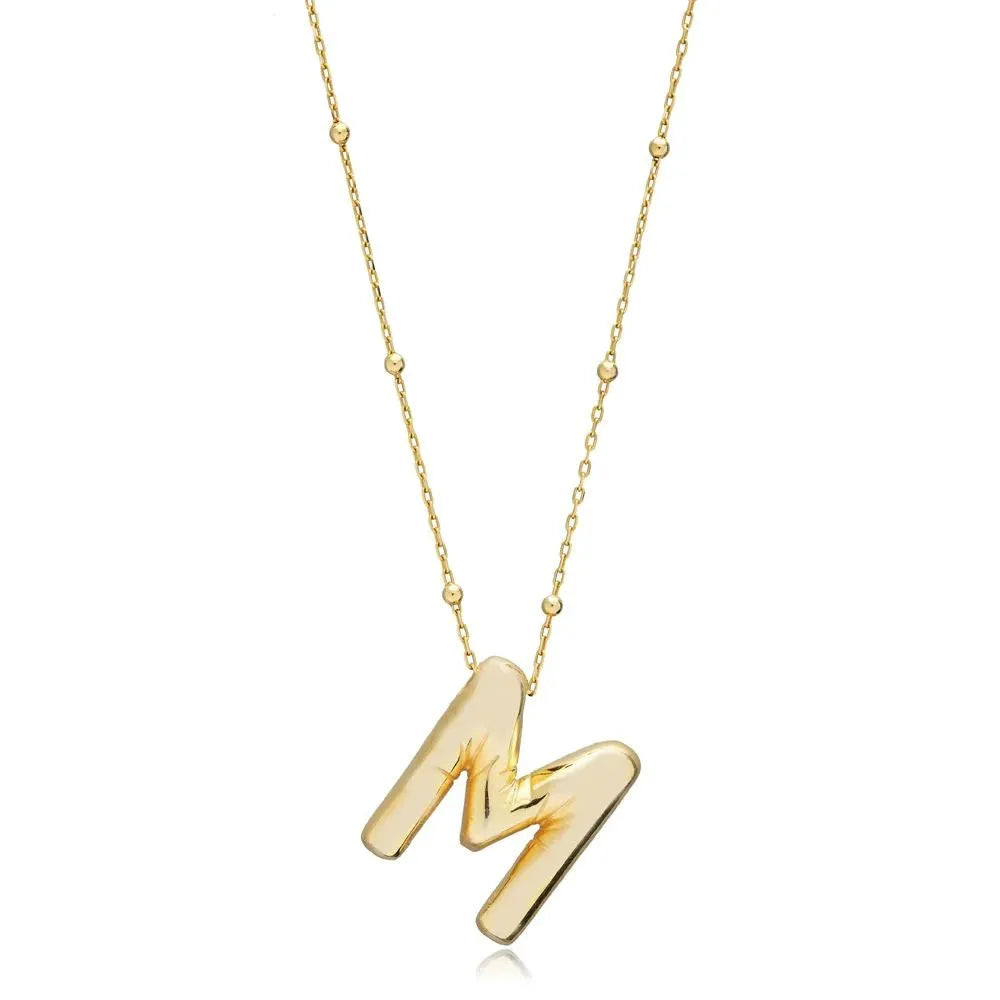A shiny 18K gold plated 3D puff initial letter M pendant on a bean chain, isolated on a white background.