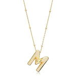 A shiny 18K gold plated 3D puff initial letter M pendant on a bean chain, isolated on a white background.