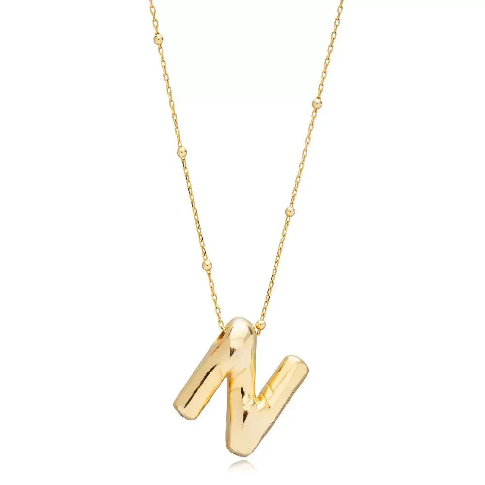 A shiny 18K gold plated 3D puff initial letter N pendant on a bean chain, isolated on a white background.