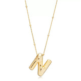 A shiny 18K gold plated 3D puff initial letter N pendant on a bean chain, isolated on a white background.