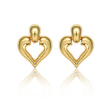 A pair of polished 18K gold plated chunky stud earrings featuring a dome top and an openwork heart design, displayed with a reflection on a clean white background.