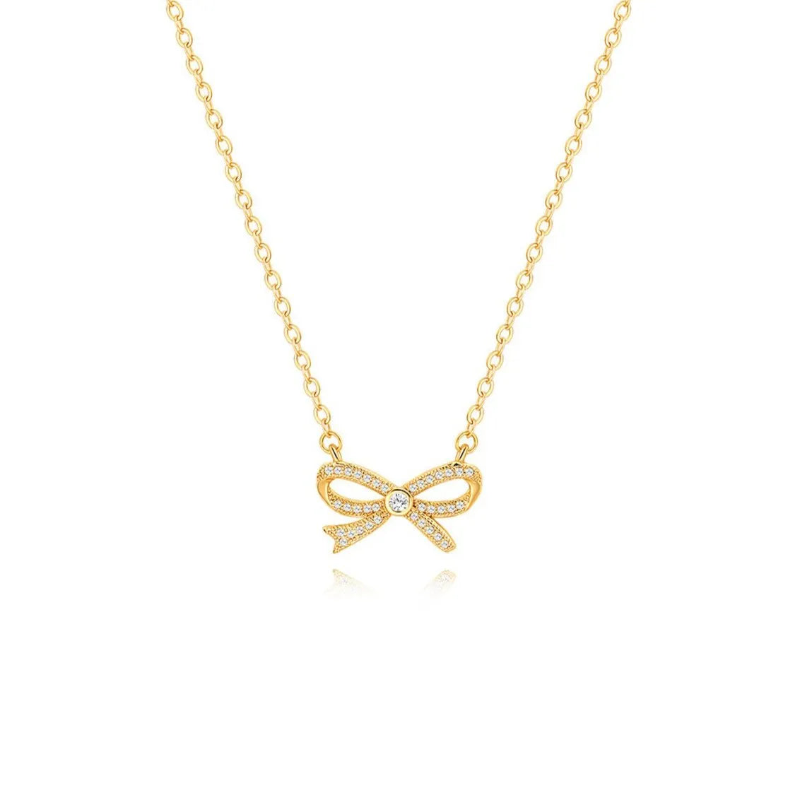 An elegant 18K gold plated bow necklace featuring micro-pave cubic zirconias and a central solitaire stone, isolated on a white background.