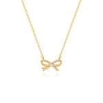 An elegant 18K gold plated bow necklace featuring micro-pave cubic zirconias and a central solitaire stone, isolated on a white background.