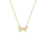 An elegant 18K gold plated bow necklace featuring micro-pave cubic zirconias and a central solitaire stone, isolated on a white background.