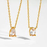 Two 18k gold plated dainty necklaces displayed side-by-side on a flat surface, showing both the oval and teardrop pendants.