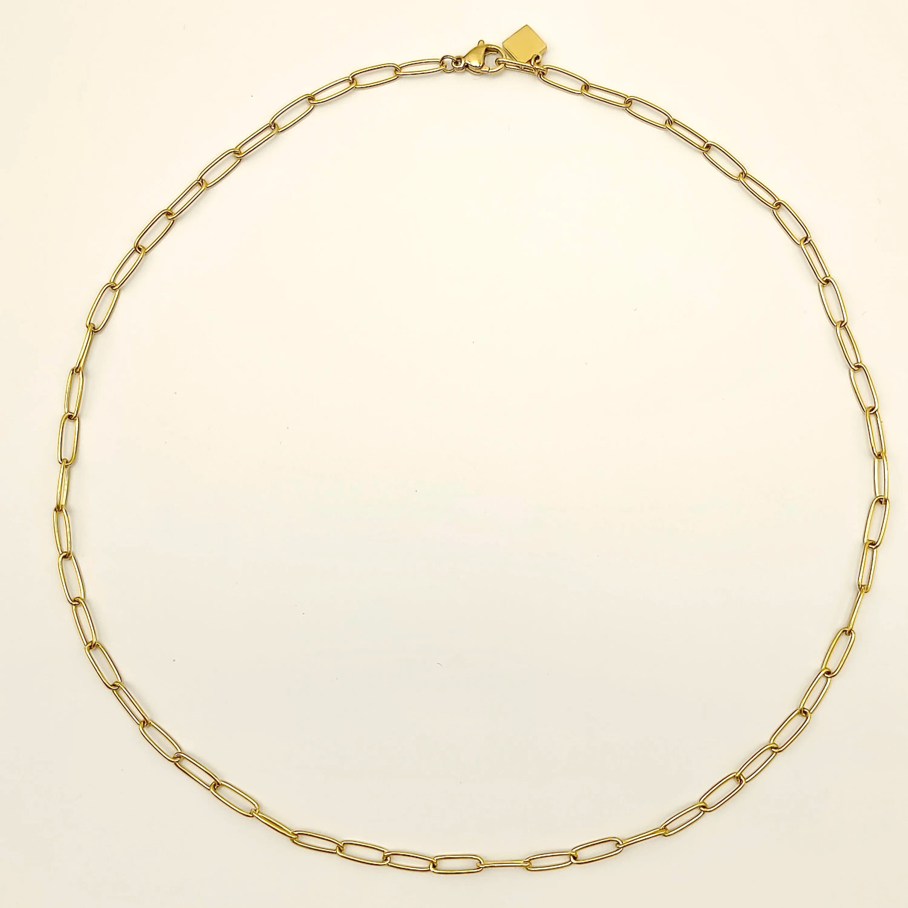 Flat lay of the complete 18K gold plated paperclip chain necklace showing its elongated links and lobster clasp on a white background.