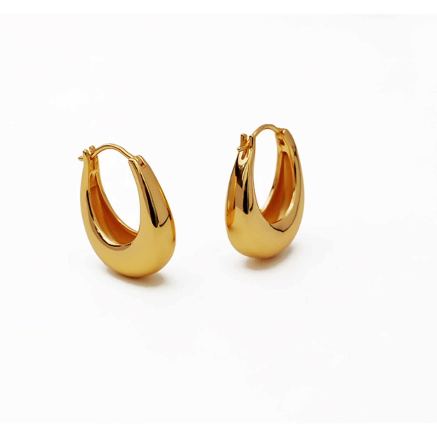 A pair of chunky 18k gold plated U-shape hoop earrings displayed against a plain white background.
