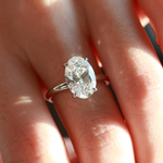 The flawless (D color, VVS2 clarity) 3 ct oval ice-flower cut solitaire ring showcased on a finger against a clean light background.