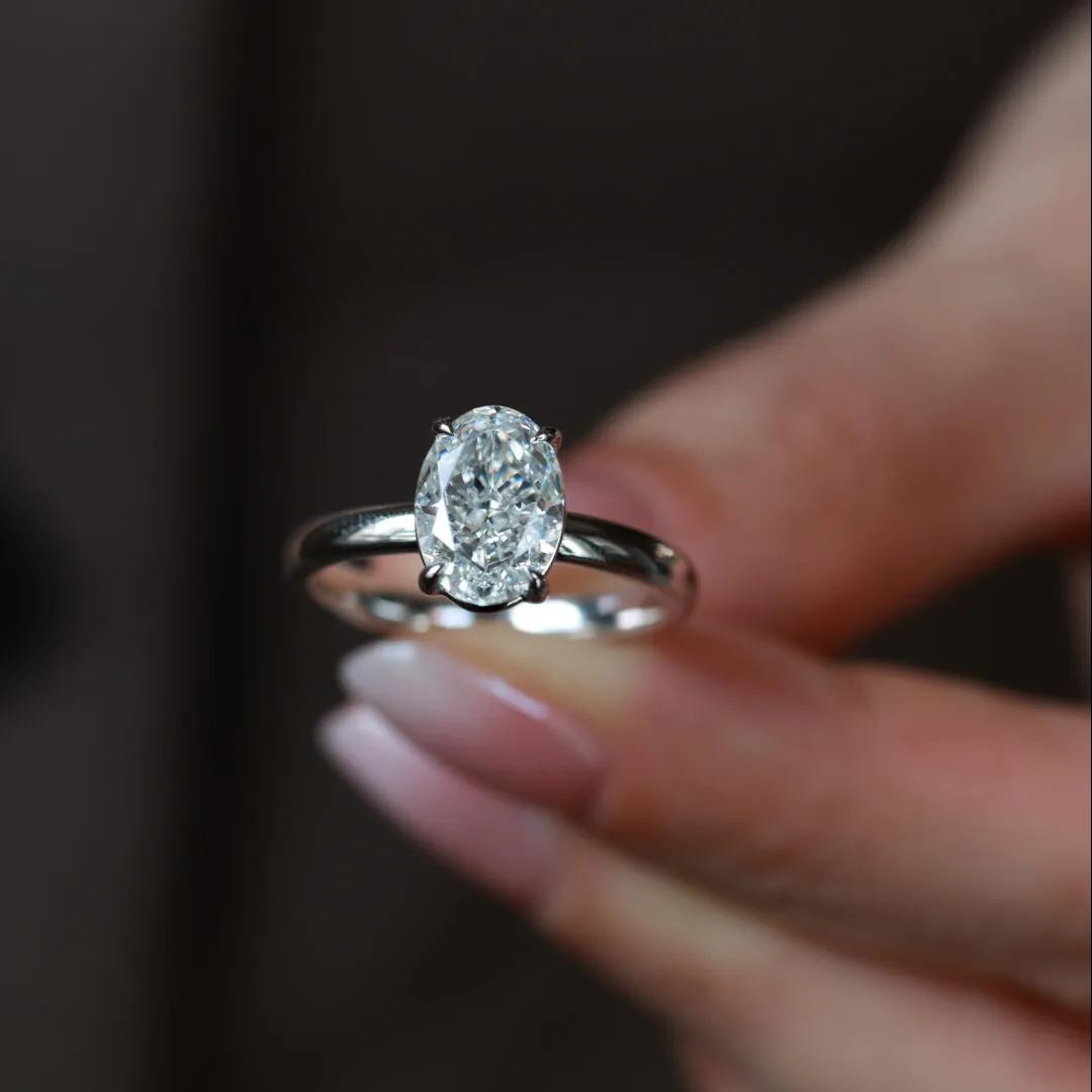 A 3 ct brilliant oval lab-grown diamond ring featuring a unique ice-flower cut, set in a minimalist four-prong solitaire.