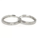 A pair of 925 sterling silver adjustable couple rings on a pure white background, clearly displaying the open-back design and custom engraving.