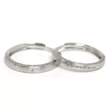 A pair of 925 sterling silver adjustable couple rings on a pure white background, clearly displaying the open-back design and custom engraving.