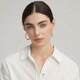 A model wearing the 5cm Solar Halo 18K gold plated chunky hoops, showcasing a bold and modern look.