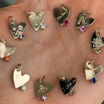 Collection of heart-shaped pendants on a wooden surface