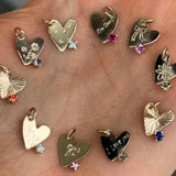 Collection of heart-shaped pendants on a wooden surface