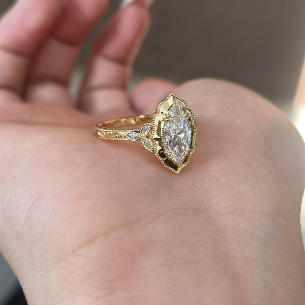 A woman's hand modeling the stunning Vintage Marquise Lab Diamond Cocktail Ring, showcasing its elongating design.