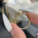 Close-up side profile of the marquise diamond ring highlighting the intricate vintage floral engravings and milgrain details on the gold band.