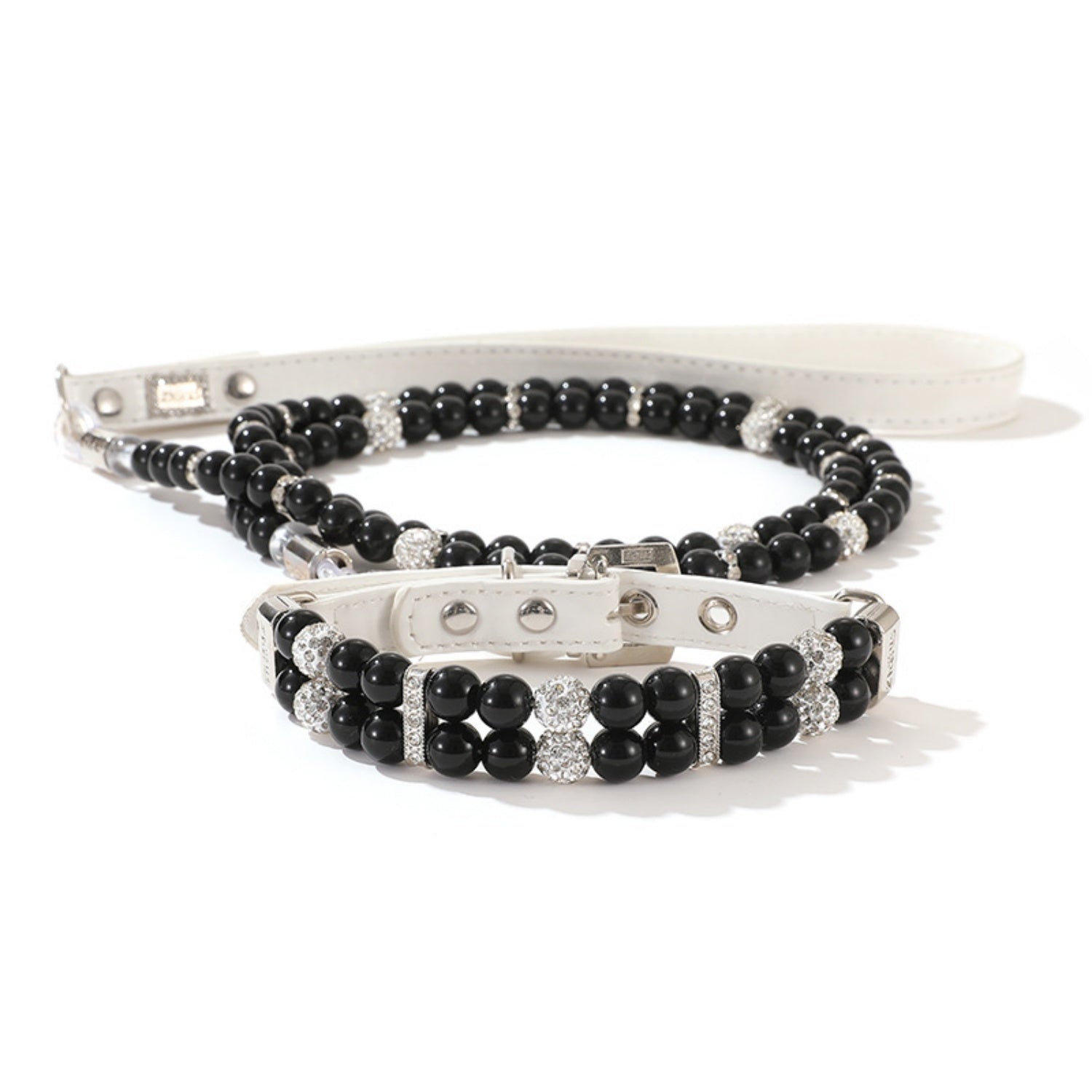 A matching set featuring a black simulated pearl pet collar resting on top of a coiled black pearl leash.