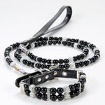 A black pearl pet collar with rhinestone spacers displayed with a matching black leash.