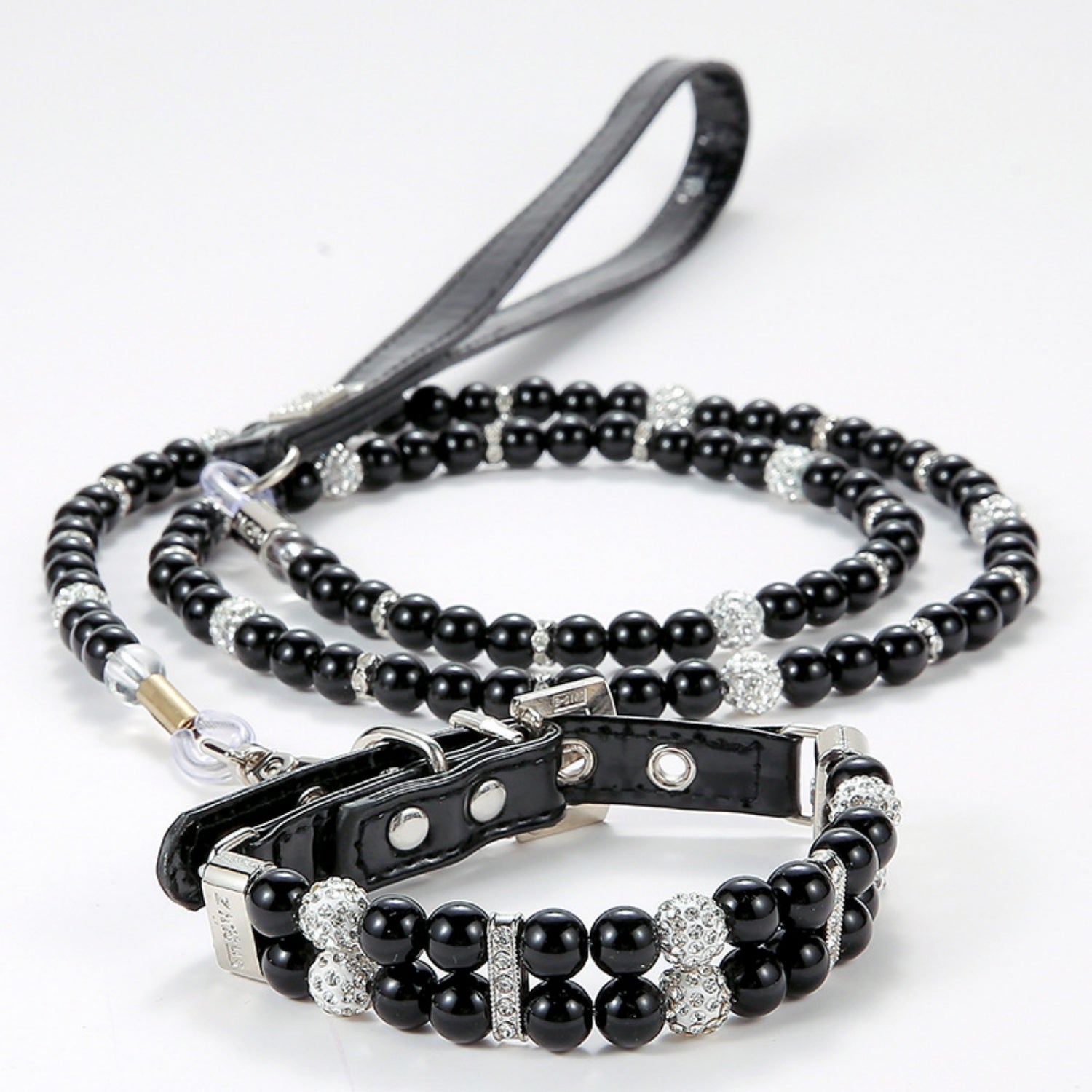 A black pearl pet collar with rhinestone spacers displayed with a matching black leash.