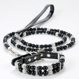 A black pearl pet collar with rhinestone spacers displayed with a matching black leash.