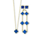 An elegant 18K gold plated jewelry set featuring a black four-leaf clover necklace, matching bracelet, and stud earrings laid on a white background.