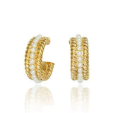 Studio product photography of a pair of gold braided croissant hoops with a center row of pearls, isolated on a white background.