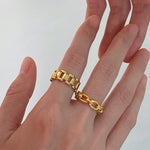 A model wearing the Chain Link Ring stacked with another gold band to showcase a layered jewelry look