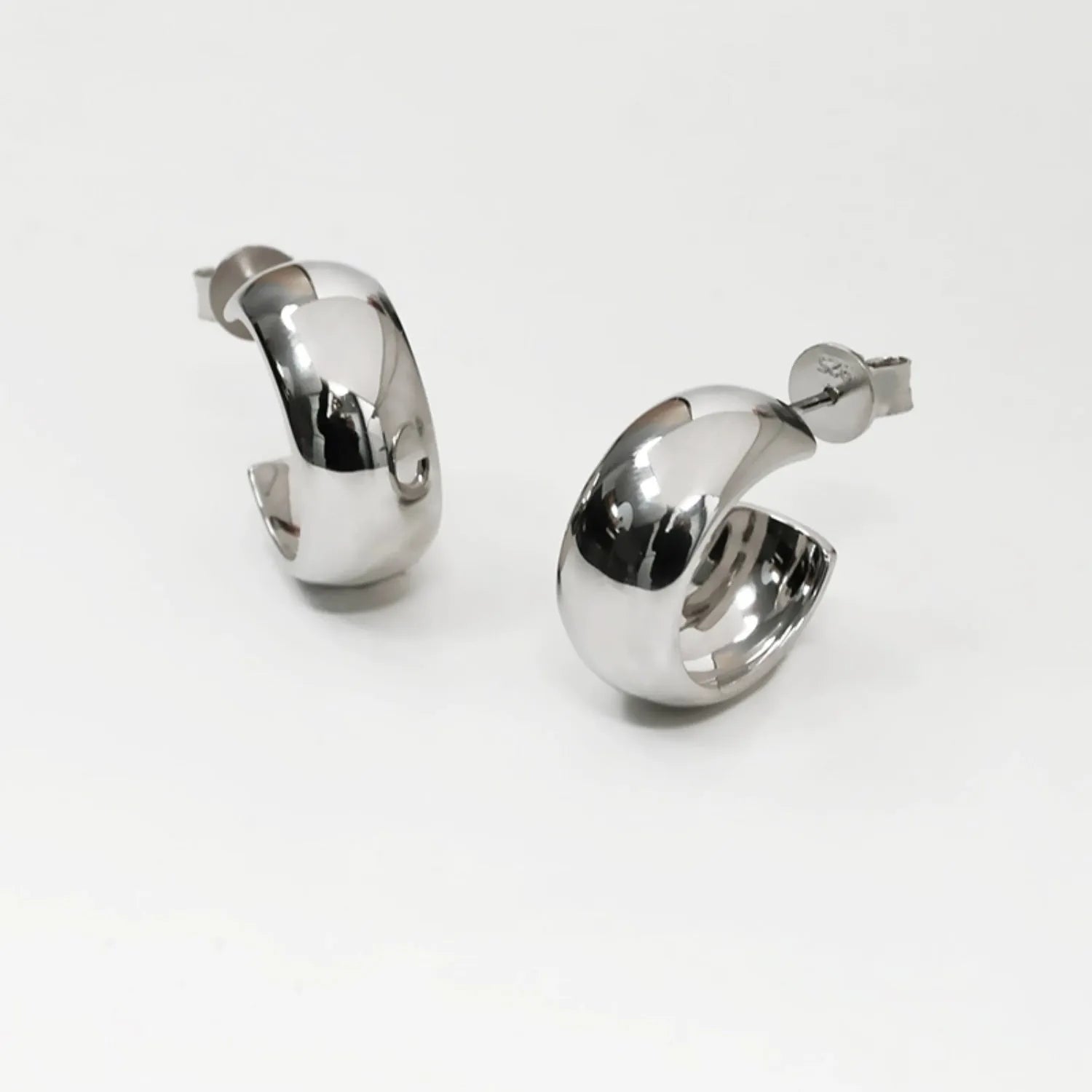 Chunky polished dome hoop earrings crafted from hypoallergenic S925 sterling silver, available in 18k gold plated and silver finishes.