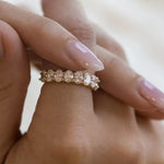 A model wearing the classic 18K gold oval lab diamond eternity ring on her finger, displaying its flattering silhouette.