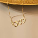 Close-up of the personalized heart necklace held in hands, showcasing the delicate script engraving and fine chain.