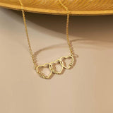 Close-up of the personalized heart necklace held in hands, showcasing the delicate script engraving and fine chain.