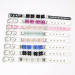 A collection of eight simulated pearl pet collars in various colors including black, hot pink, light pink, mint green, royal blue, and white, laid flat horizontally against a white background.