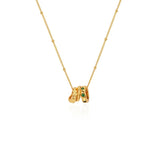 Professional studio shot of the 18K gold-plated Emerald Trio Ring Necklace on a clean white background.