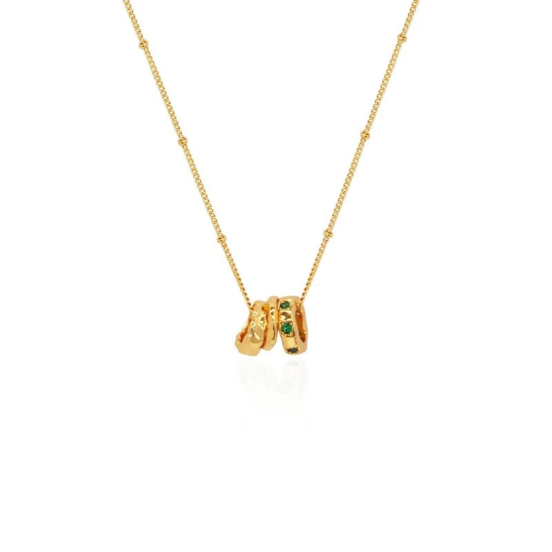Professional studio shot of the 18K gold-plated Emerald Trio Ring Necklace on a clean white background.