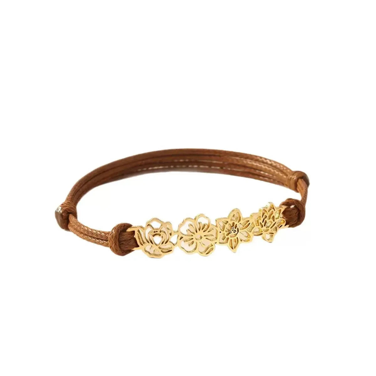 A custom gold birth flower bracelet featuring four distinct month flower charms strung on an adjustable brown waxed cotton cord.