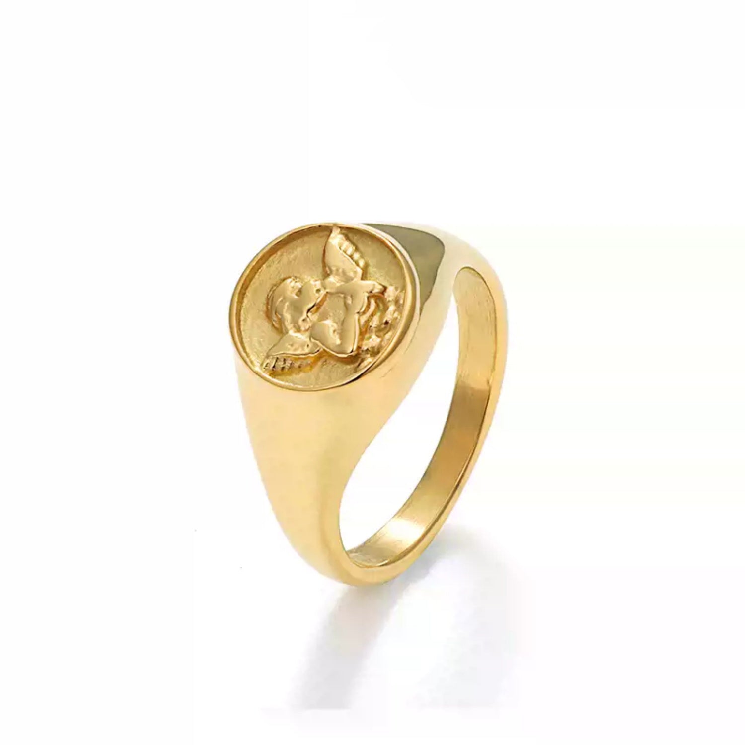 A gold signet ring featuring a raised, embossed angel or cherub design, isolated on a clean white background.
