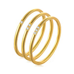 The 3-piece 18K gold plated stackable ring set arranged aesthetically to show their individual designs.