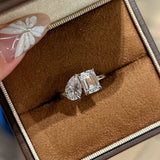 Close-up shot of the sparkling 1.5ct emerald and 1.5ct pear cut high-carbon diamonds on the Toi et Moi ring resting in a box.