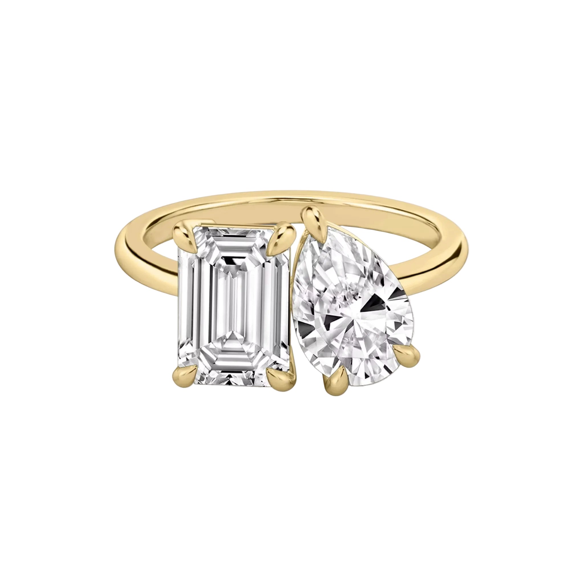 Studio shot of the yellow gold plated Toi et Moi ring featuring pear and emerald cut stones on a white background.