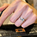 A woman's hand holding a black leather bag, wearing the elegant S925 silver Toi et Moi two-stone ring.