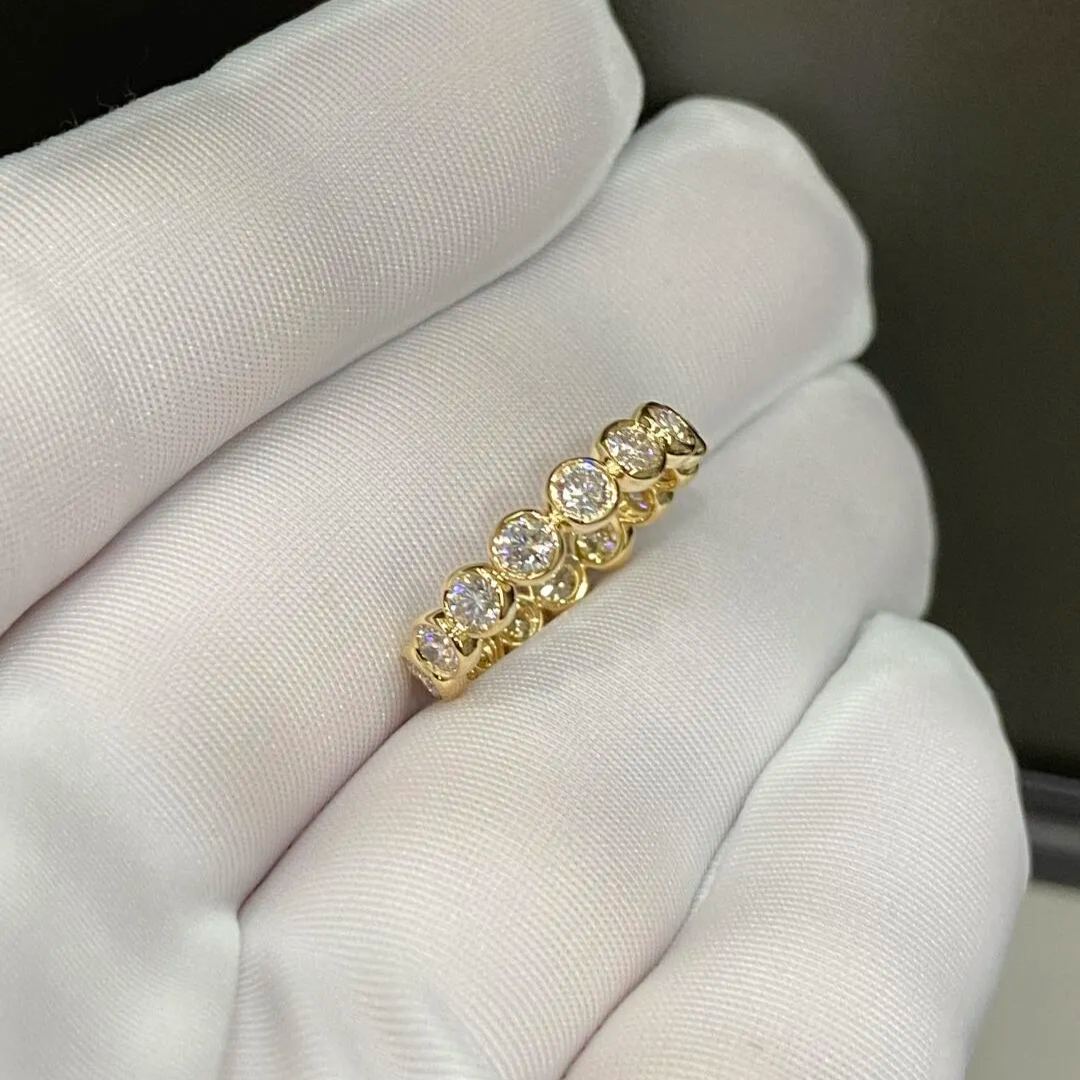 Gold ring with diamonds on a white cloth background