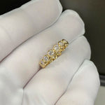 Gold ring with diamonds on a white cloth background