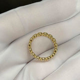 A woman's finger wearing the Bubble Eternity Band, highlighting its seamless 360-degree shimmer and comfortable fit.