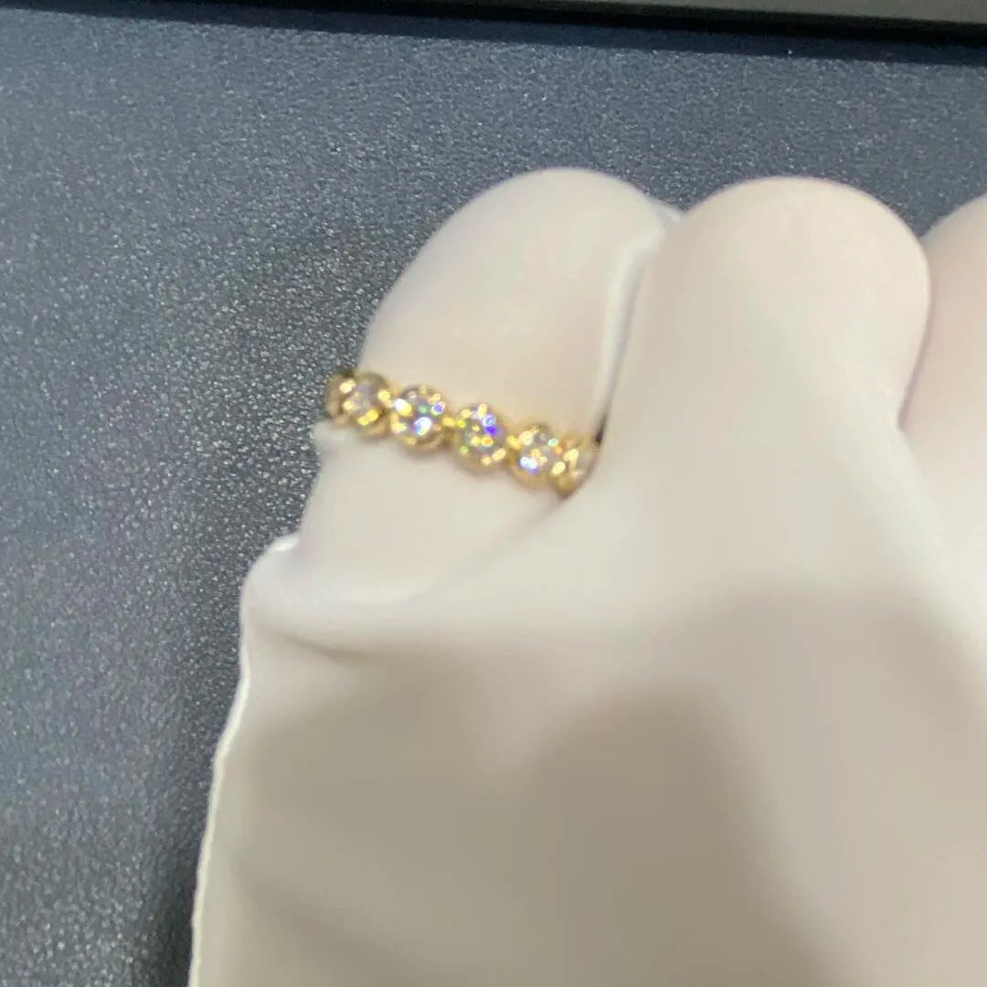 A woman's finger wearing the Bubble Eternity Band, highlighting its seamless 360-degree shimmer and comfortable fit.