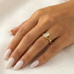 A model wearing the 18K solid gold flexible wrap ring, showcasing the 1-carat marquise lab diamond and unique woven chain design on the finger.